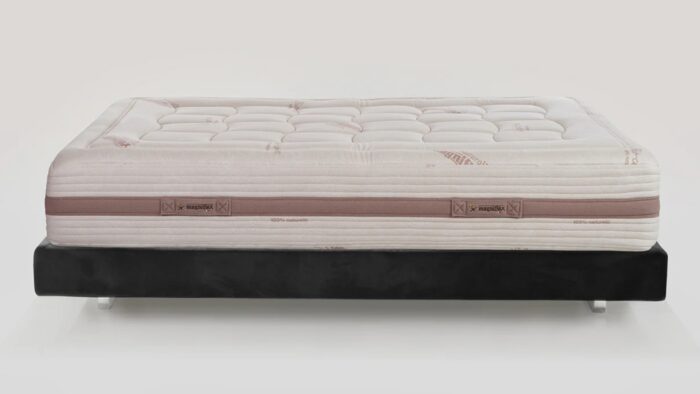 Plush cream quilted mattress on black minimalist bed frame, tranquil and luxurious design.