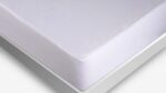 White mattress on minimalist frame, featuring plush corners and serene ambiance.