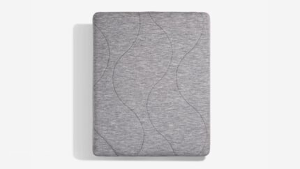 Gray mattress with wavy stitching on a white background suggesting comfort and elegance.