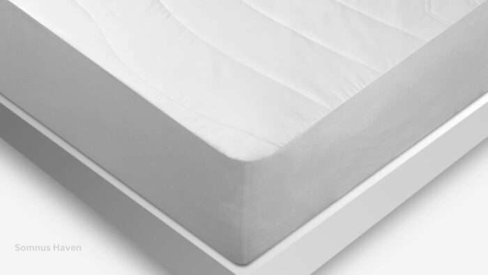 Modern white mattress with quilted pattern on minimalist bed frame, emphasizing comfort and style.