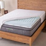 Gel-infused memory foam mattress in modern wood-framed bedroom with bohemian decor.