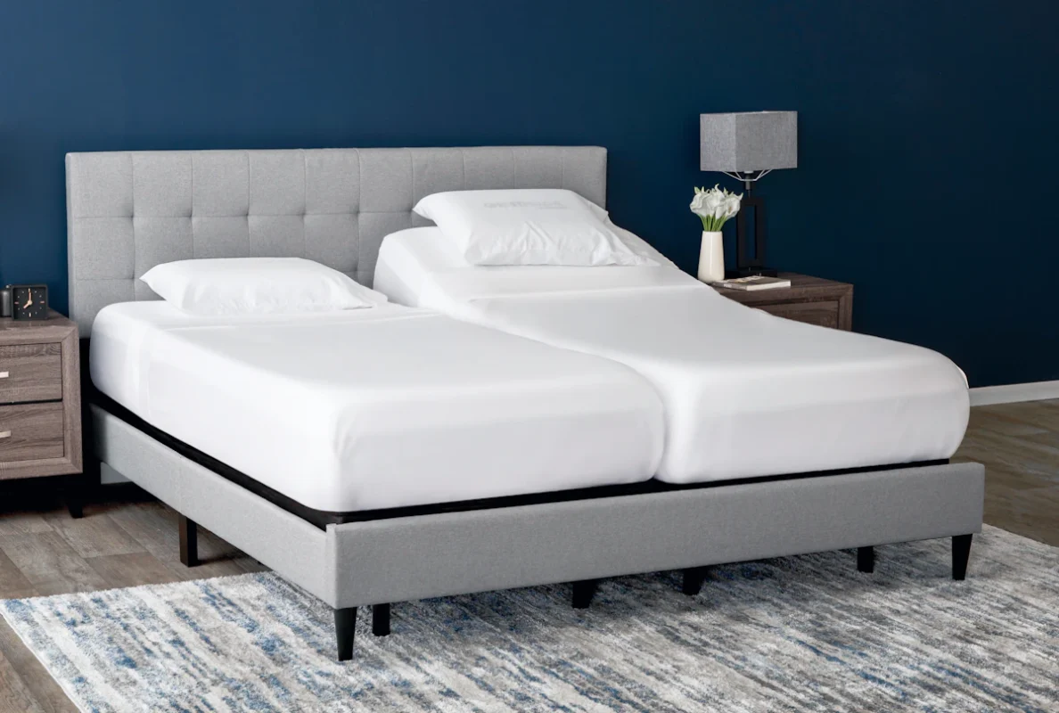 Modern split king adjustable bed in minimalist bedroom with deep blue accents.