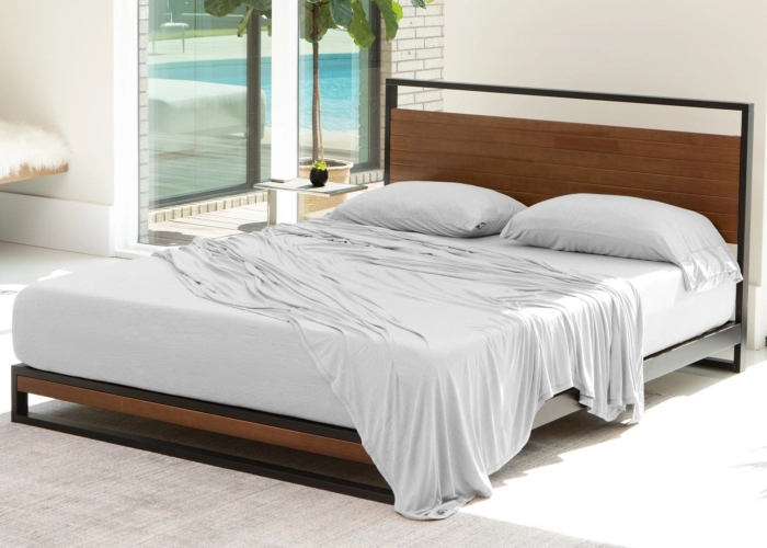 Modern bed with metal frame, wooden accents, sunny serene bedroom, natural light, tranquility.