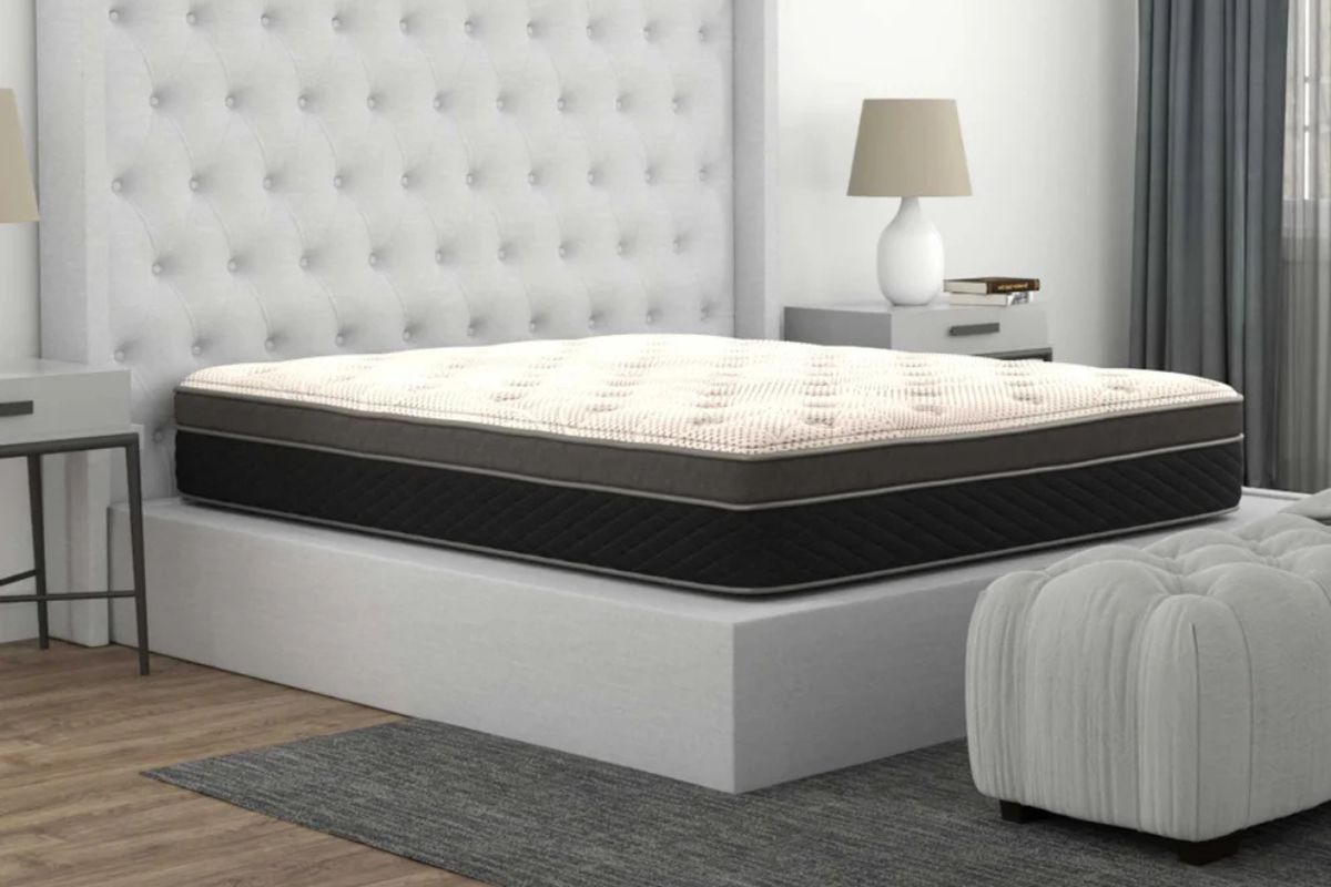 Modern bedroom with plush mattress, tufted headboard, sleek nightstand, and natural light.