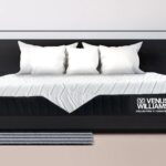 Contemporary dark wood bed with elegant bedding, pendant lighting, and minimalist decor.