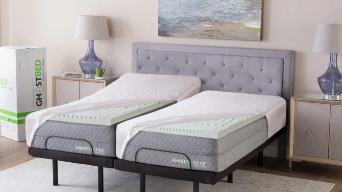 Twin beds with GhostBed mattresses, modern decor, gray headboard, and lavender lamps.