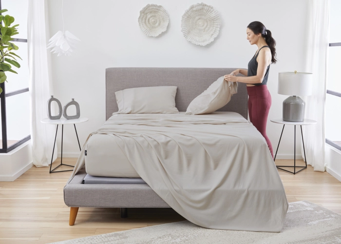 Modern minimalist bedroom with tufted headboard, natural light, cozy atmosphere, and stylish decor.