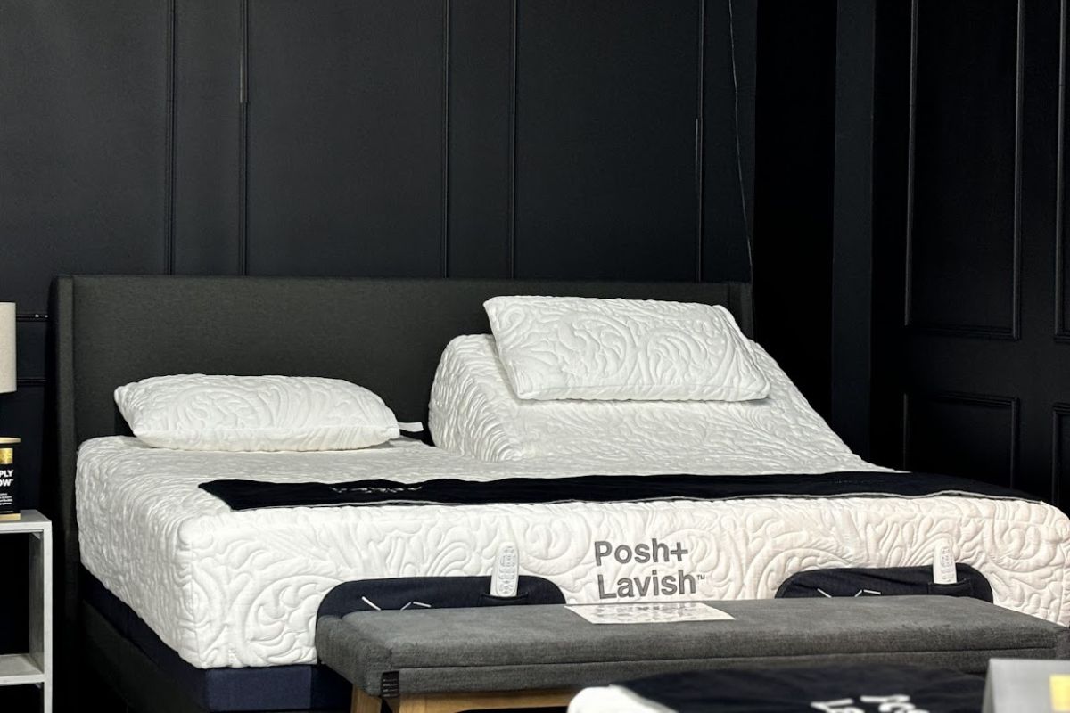 Modern bedroom featuring Posh+Lavish bed, quilted mattress, dark tones, and functional bench.