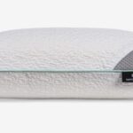 Modern ergonomic pillow with plush gray cover, aqua accents, and supportive design for better sleep.