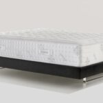 Plush modern mattress on minimalist bed frame for ultimate comfort and style.