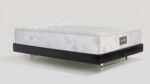 Plush modern mattress on minimalist bed frame for ultimate comfort and style.