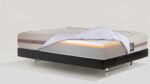 Contemporary mattress set with layered design on sleek platform bed for modern bedroom style.