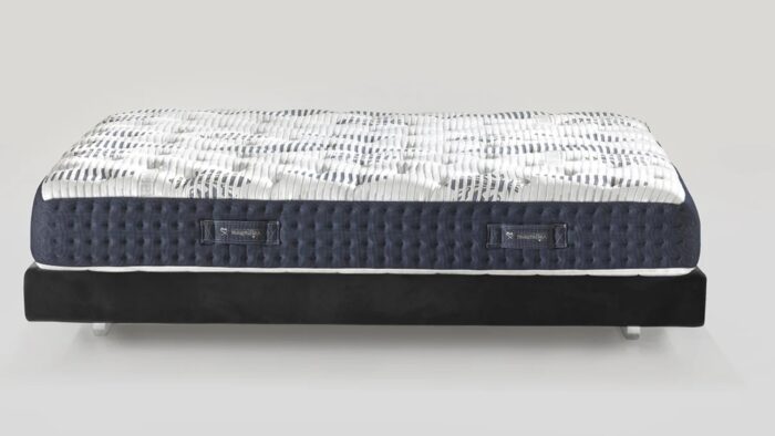 Modern mattress with wave design on minimalist dark base for stylish comfort.