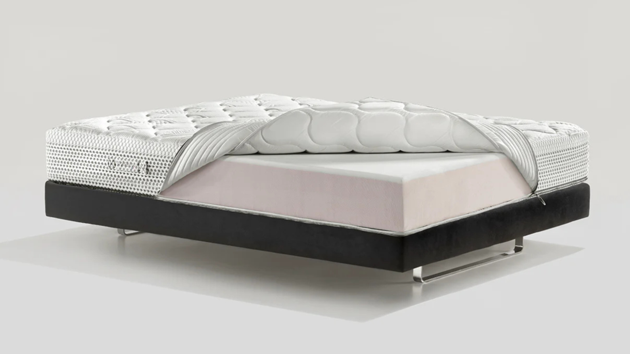 Luxurious modern bed with ergonomic quilted mattress and sleek black foundation with metal legs.