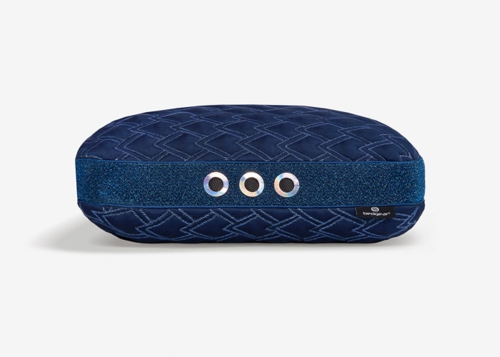 Elegant navy quilted cosmetic pouch with contrasting band and metallic eyelets for versatile storage.