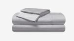 Luxurious gray bedding set featuring high-thread-count sheets for elegant, minimalist bedroom decor.