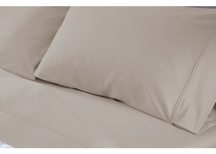 Neutral bedding with elegant beige pillows for a cozy, minimalist sleep environment.