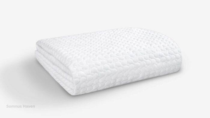 Textured white ergonomic pillow for comfort and support in a minimalist setting.