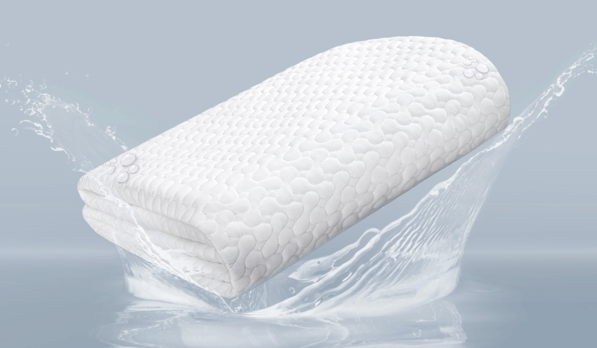White textured pillow partially submerged in water, suggesting luxury and water resistance.