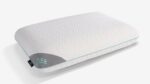 Ergonomic Rise pillow in soft white with gray panel, enhances sleep comfort and support.