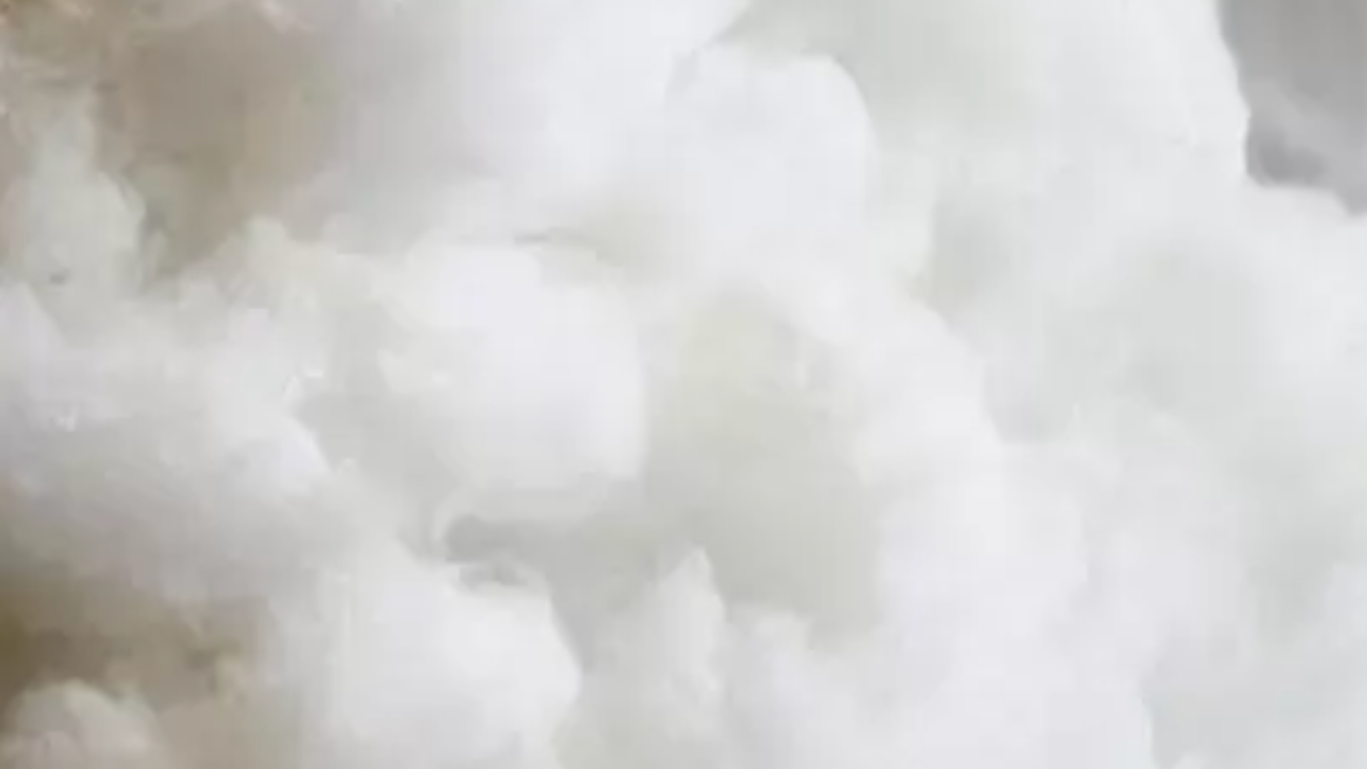 Fluffy white material close-up, resembling clouds, evoking serenity, purity, and comfort.