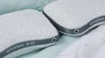 Modern white geometric pillows with grey trim on mint bedding, STORM 3.0 design.