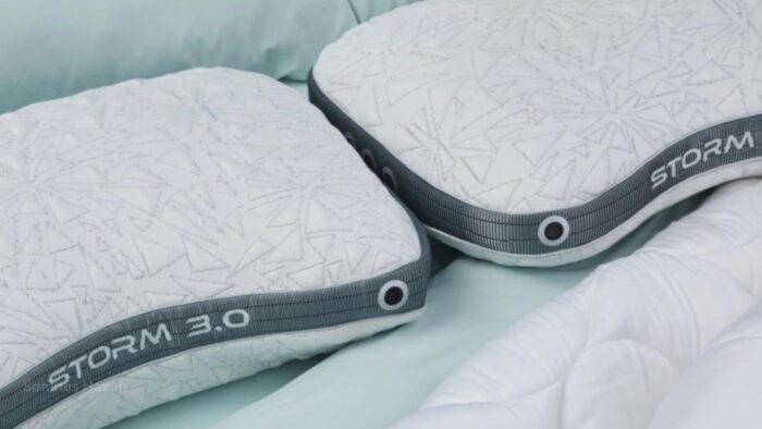 Modern white geometric pillows with grey trim on mint bedding, STORM 3.0 design.