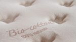 Organic bio-cotton mattress with tufted design for eco-friendly, luxurious sleep.