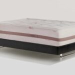 Luxury cream mattress with elegant stitched design and modern base for comfort and style.