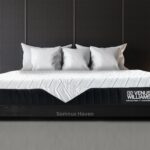 Modern bedroom with Venus Williams Somnus Haven mattress, dark wood bed, and cozy white pillows.