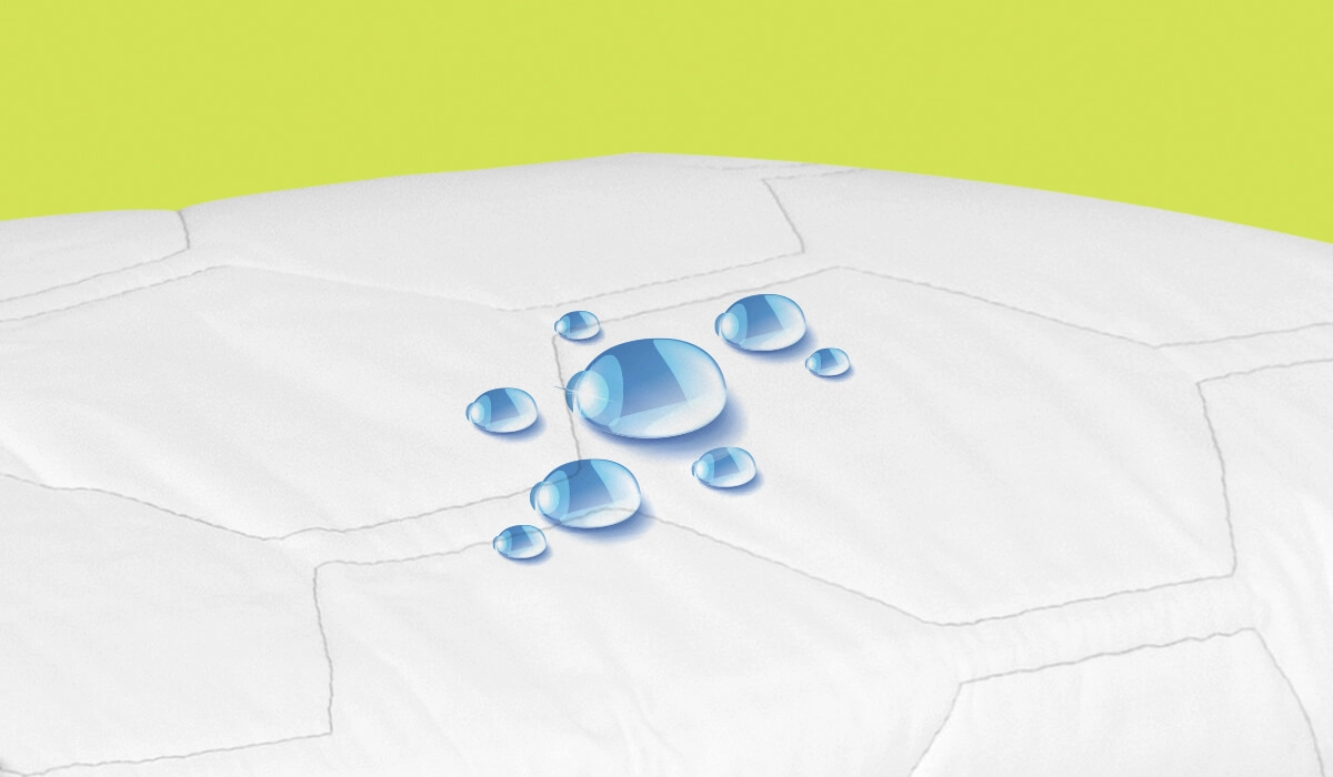 Quilted waterproof mattress cover with water-resistant features and blue-tinted droplets.