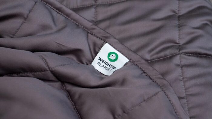 Luxurious gray weighted blanket with quilting, promoting relaxation and improved sleep quality.