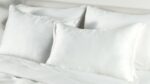 Minimalist white bedding set exuding luxury and tranquility for peaceful relaxation.