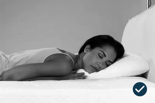 Serene woman sleeping peacefully in minimalist black-and-white scene, capturing tranquility and rest.